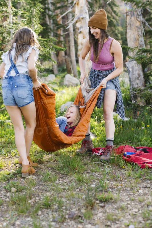 Woman playing in forest with son (6-7) and daughter (8-9)