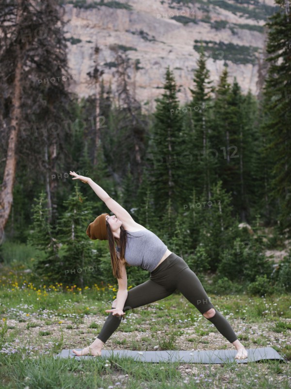 Woman practicing yoga in forest