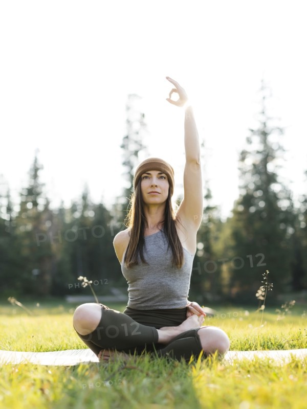 Woman practicing yoga in forest