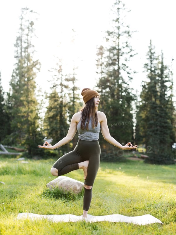 Woman practicing yoga in forest