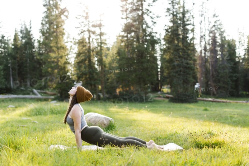 Woman practicing yoga in forest