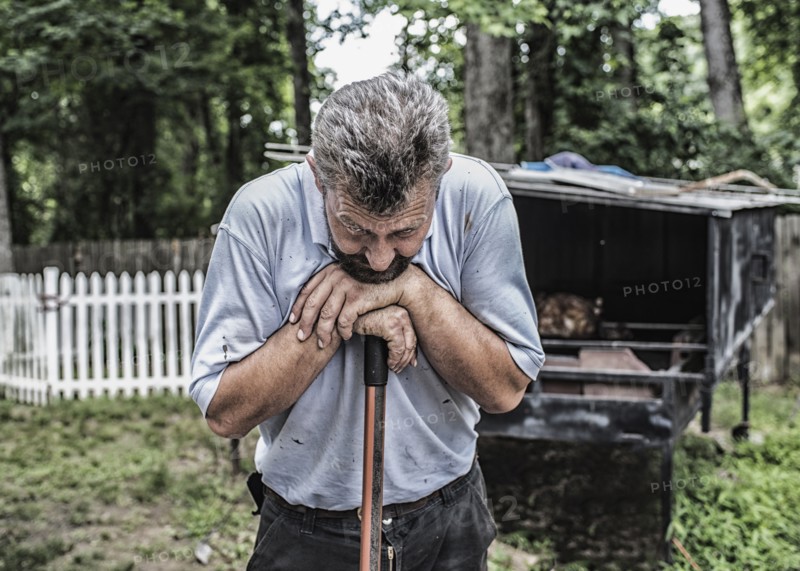 Man working by traditional Bosnian cook hut in backyard