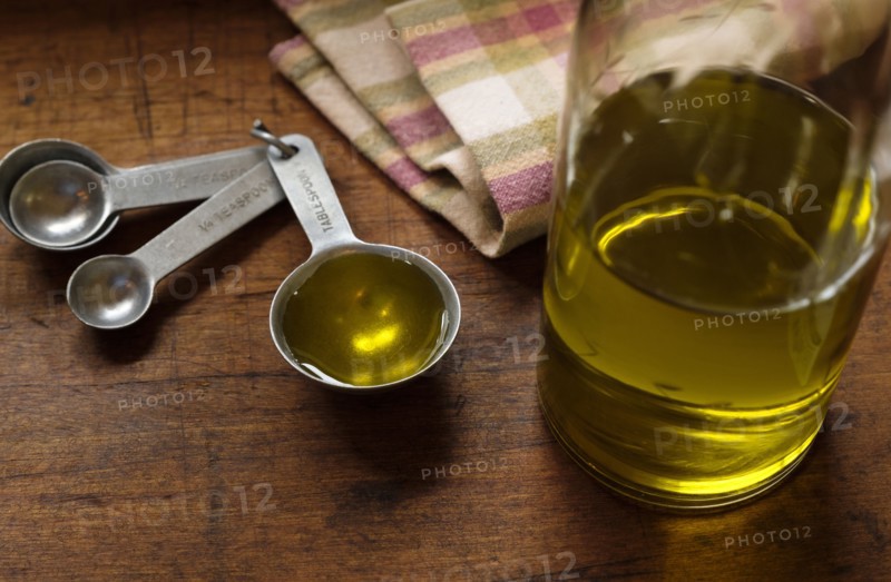 Measuring spoon, olive oil and napkin