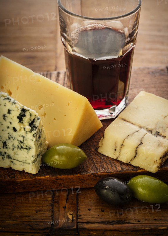 Assorted cheeses with olives and red wine