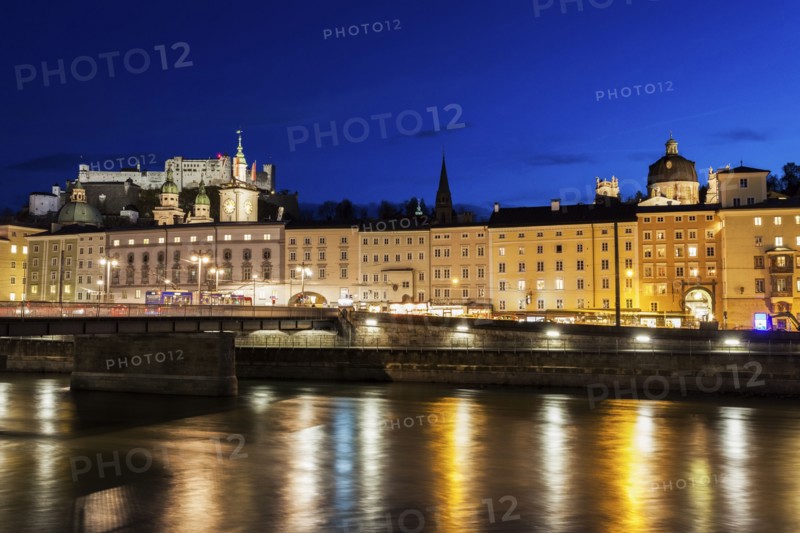 Austria, Salzburg, Riverbank with buildings at night