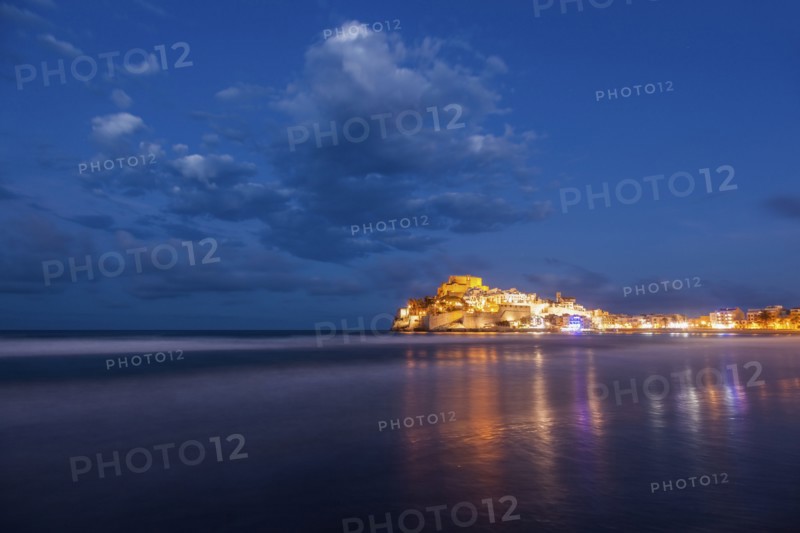 Spain, Valencian Community, Peniscola, Illuminated town by sea