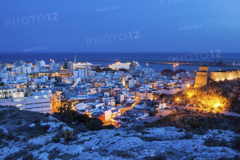 Spain, Andalusia, Almeria, Cityscape with sea at dusk