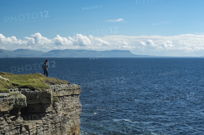 Ireland, Donegal County, Muckross Head, Woman standing on top of cliff