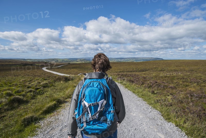 Ireland, Cavan County, Cuilcagh Mountain Park, Woman hiking along road