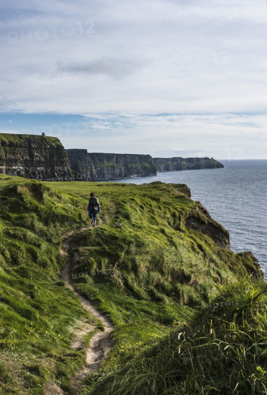 Ireland, Clare County, Woman walking along Cliffs of Moher