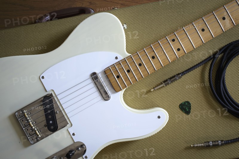 Fender Telecaster and music equipment lying on guitar case