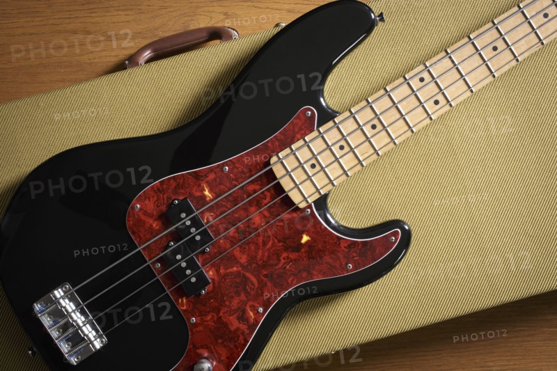 Bass guitar lying on guitar case