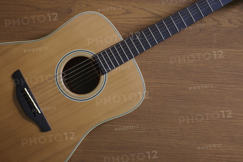 Acoustic guitar lying on floor