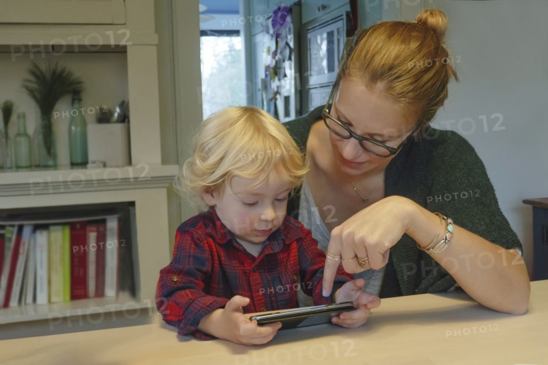 Mother and son (2-3) playing on smart phone