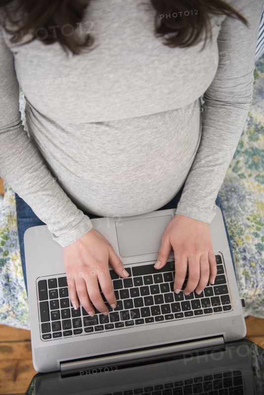 High angle view of pregnant woman using laptop