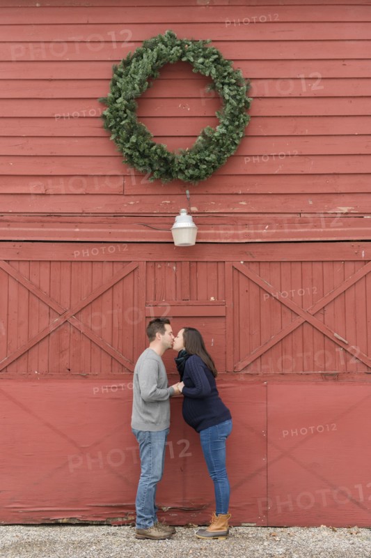 Couple kissing below wreath
