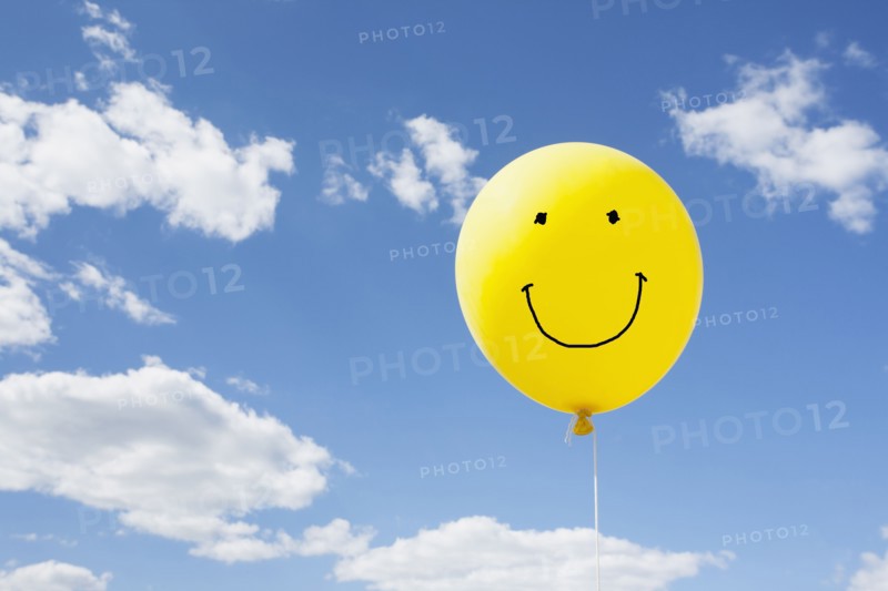 Yellow balloon in blue sky