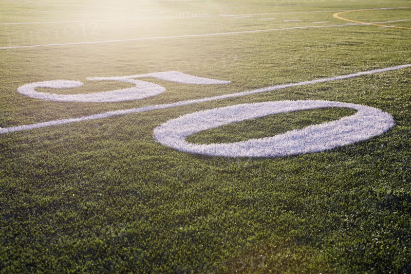 Fifty yard line on green playing field