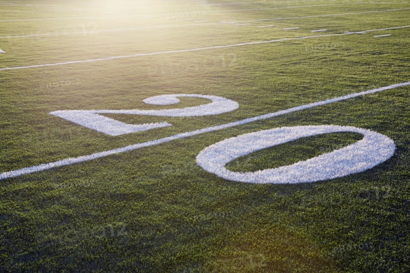 Twenty yard line on green playing field