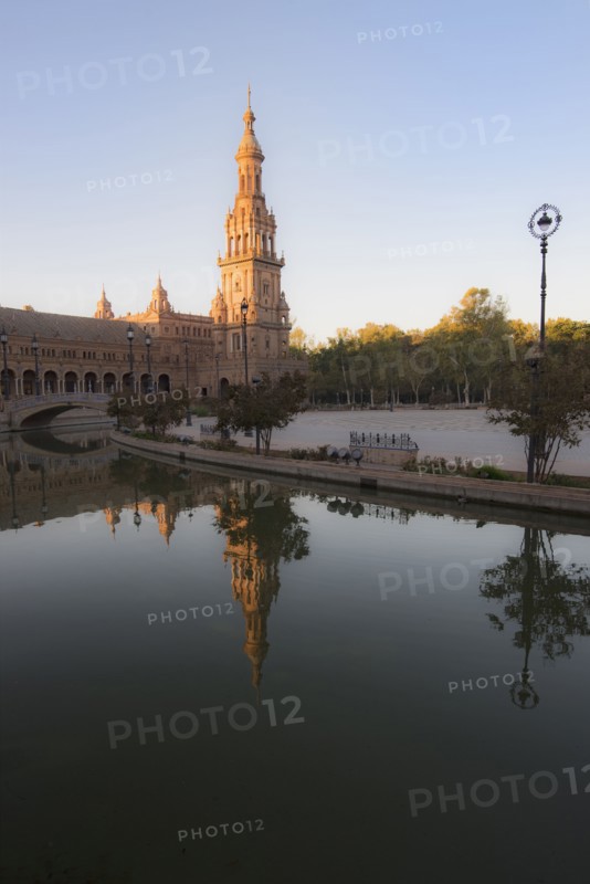 Spain, Andalusia, Seville, Tower in Plaza de Espana reflected in water