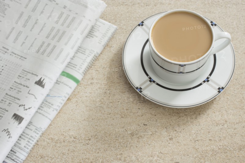 Newspaper and coffee on table