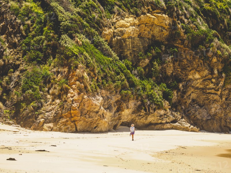 Australia, New South Wales, Bermagui, Woman walking along beach
