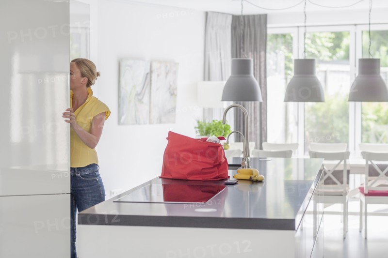 Woman unpacking groceries from shopping bag