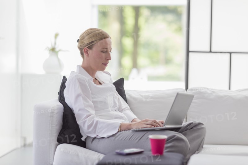 Woman using laptop in living room