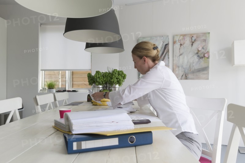 Mature woman working at table
