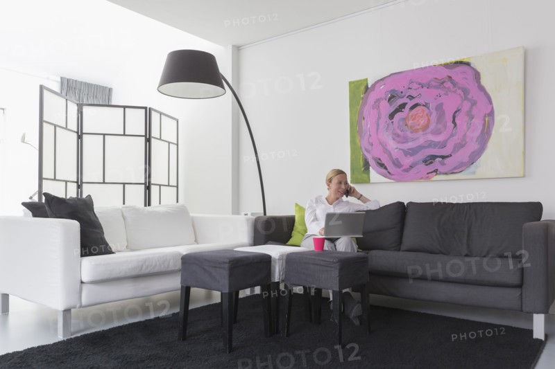 Mature woman sitting in modern living room