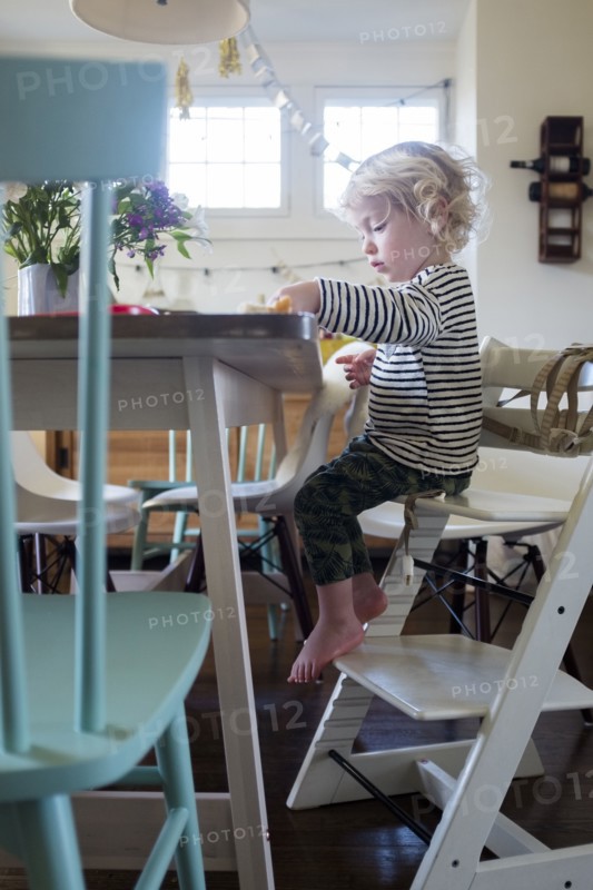 Boy at table on step ladder