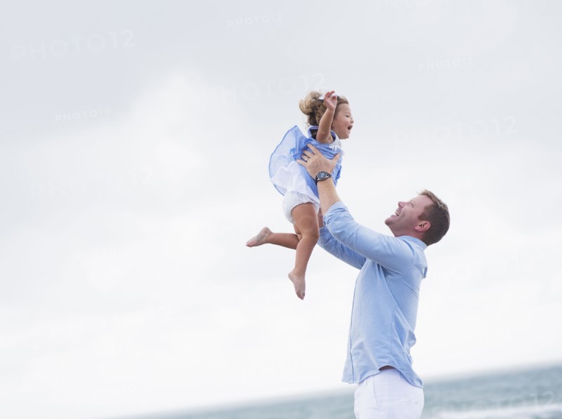 Father lifting daughter