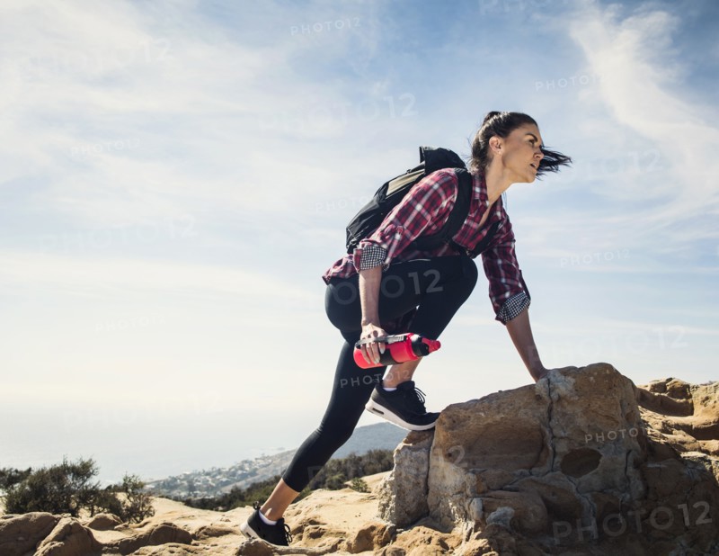 Woman hiking over rocks