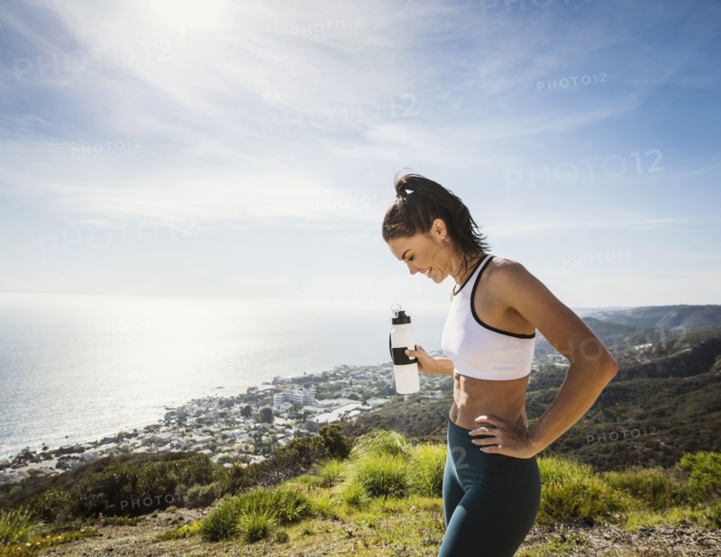 Woman in sportswear with water bottle