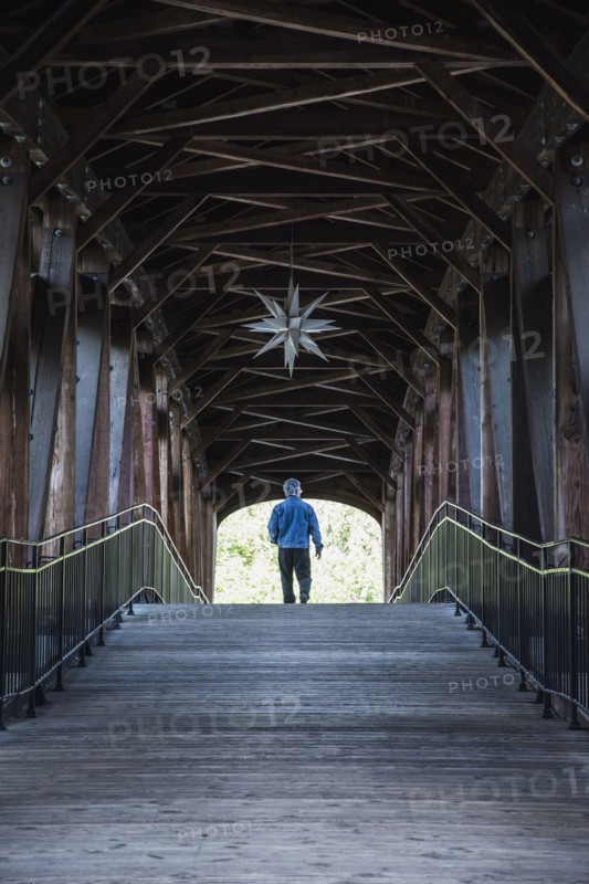 Man on covered bridge