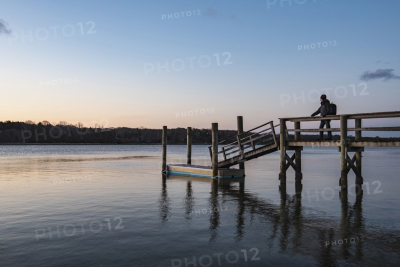 Silhouette of man on pier