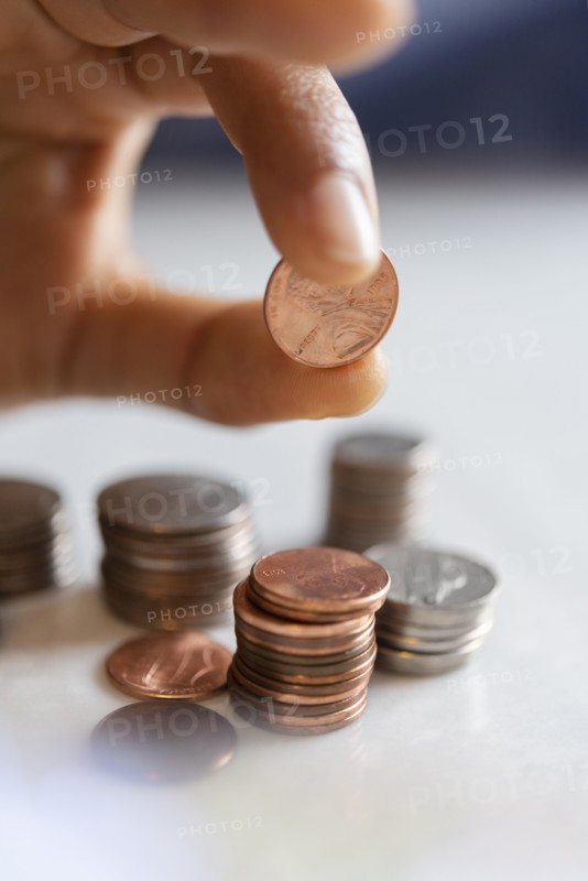 Hand of woman stacking coins