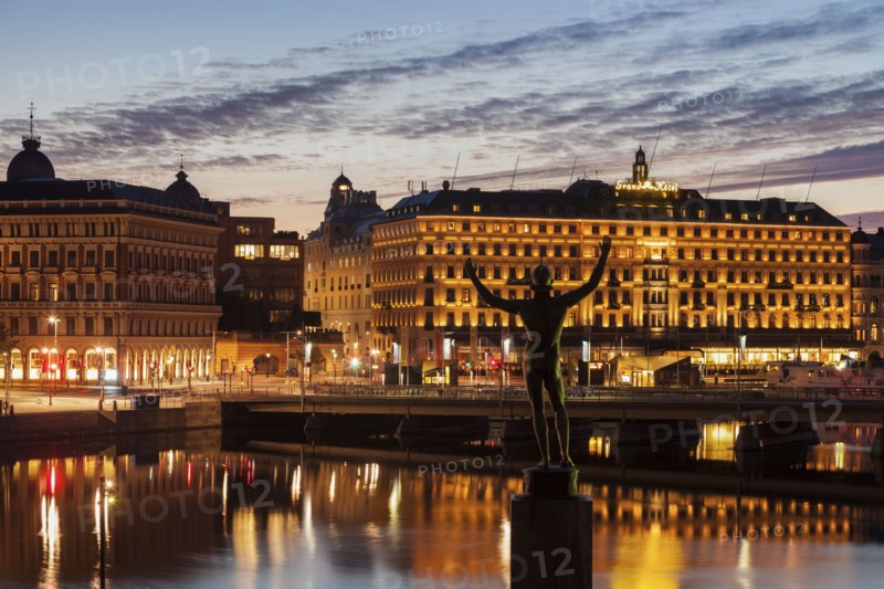 Statue by buildings at sunset in Stockholm, Sweden