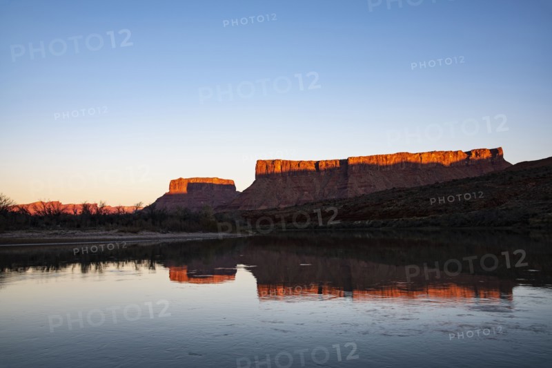 Cliffs by Colorado River at sunset in Utah, USA