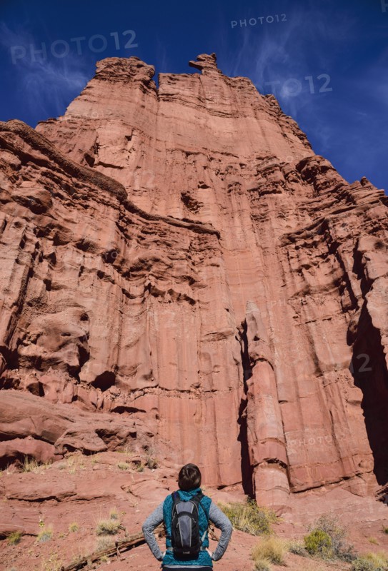 Woman standing by Fisher Towers in Utah, USA