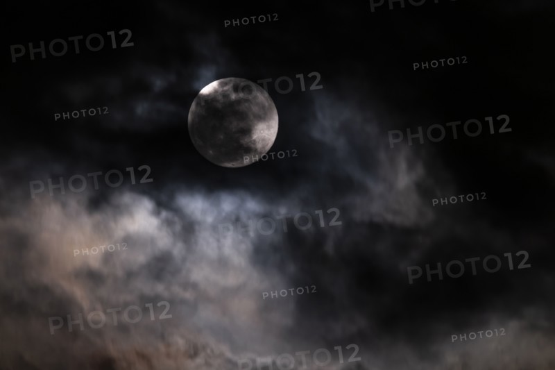 Full moon among clouds