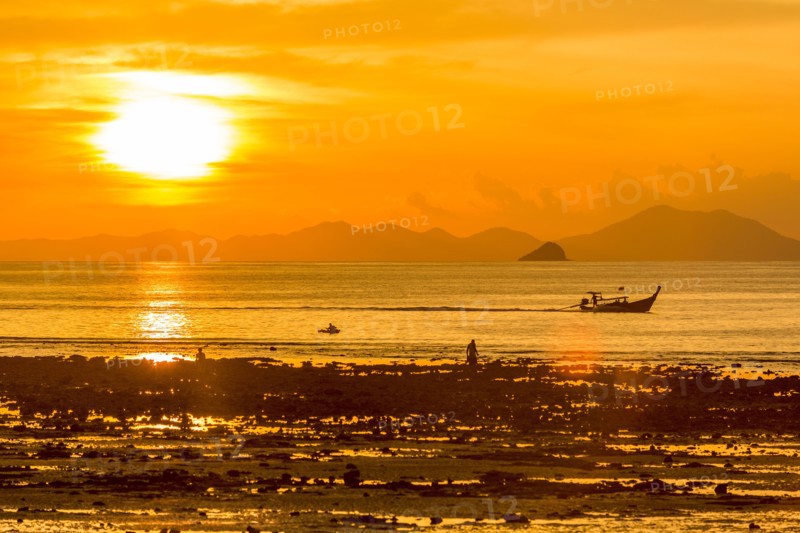 Silhouette of boat at sunset in West Railay, Thailand