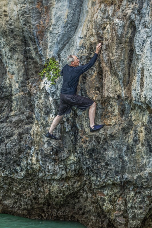 Man rock climbing in Phuket, Thailand