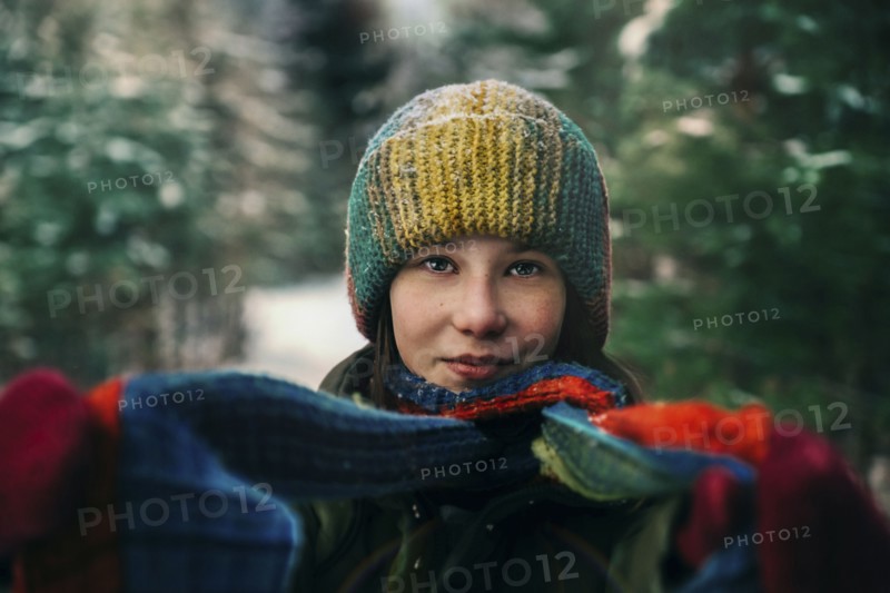 Teenage girl with colorful woollen hat and scarf during winter