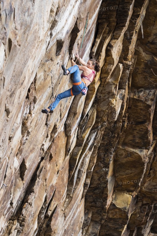 Teenage girl rock climbing