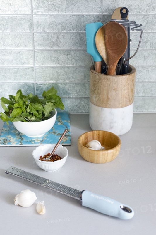 Grater with garlic on kitchen counter