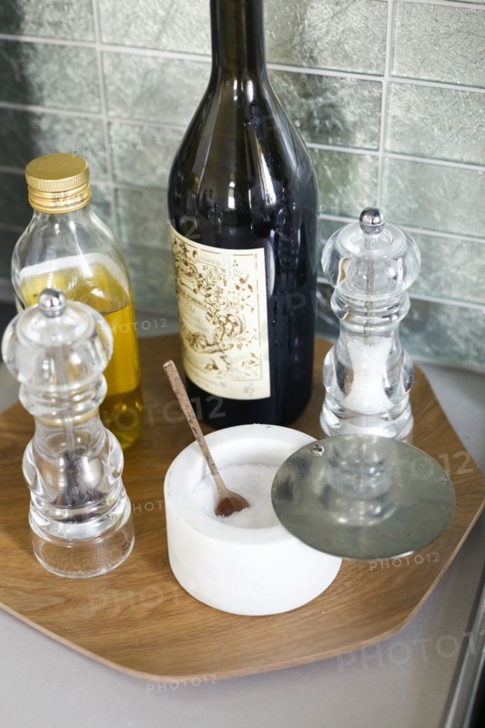 Oil, salt and pepper on tray in kitchen