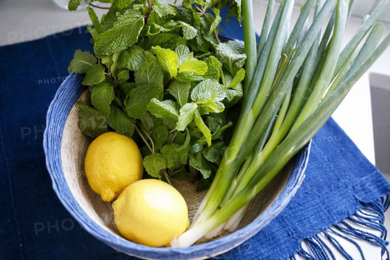 Bowl of mint, lemons and spring onions