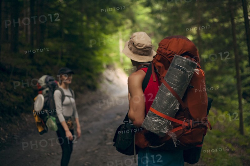 Couple hiking in forest at the Carpathian Mountain Range, Ukraine