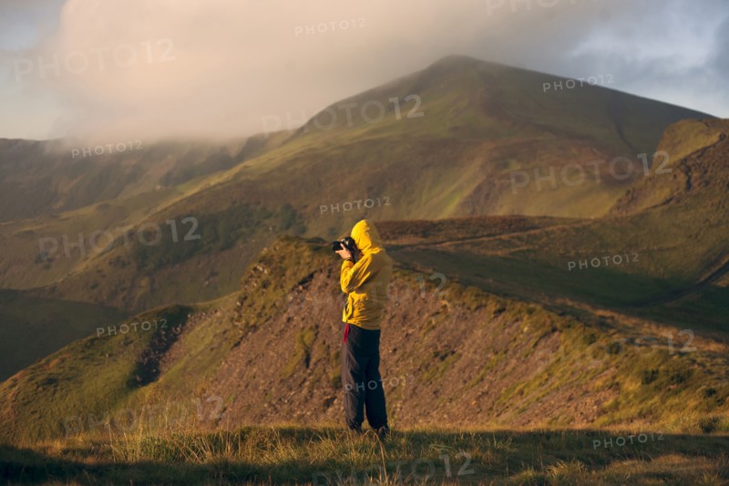 Man in yellow jacket taking photographs in the Carpathian Mountain Range